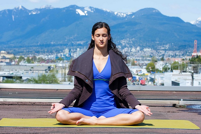 woman doing yoga in mountains
