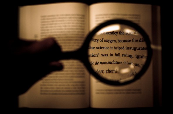 book and magnifying glass