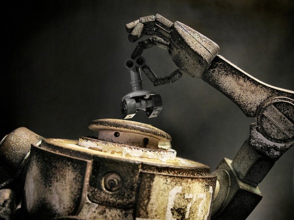 Automaton robot holding smaller robot overhead