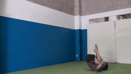 Someone doing a squat jump, by rolling forward into a squat then jumping up.