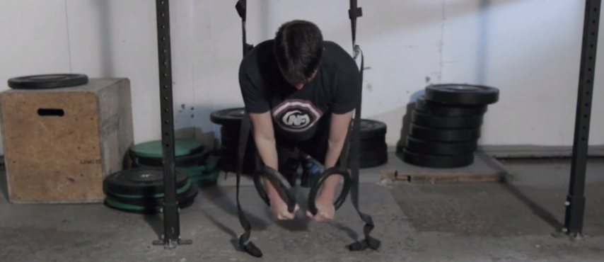 Holding yourself up at the peak of a push-up is another great beginner move with gymnastic rings.