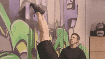 Lifting one leg during a wall walk is how we'll start our full handstand.