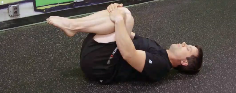 Grab your legs like you are doing a cannonball.