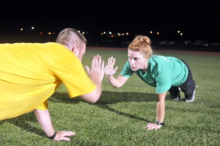 A personal trainer high-fiving a client. 