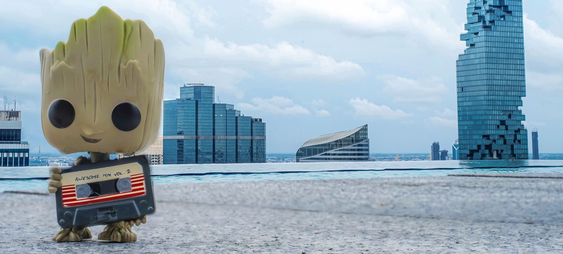 Baby Groot holding an awesome mixtape. 