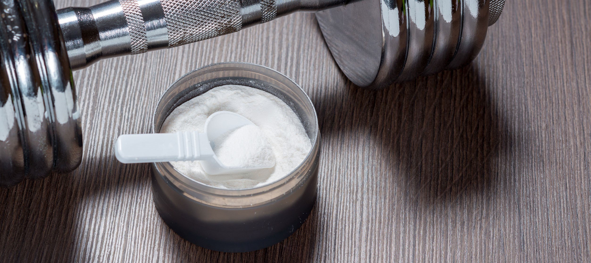 Creatine and a dumbbell