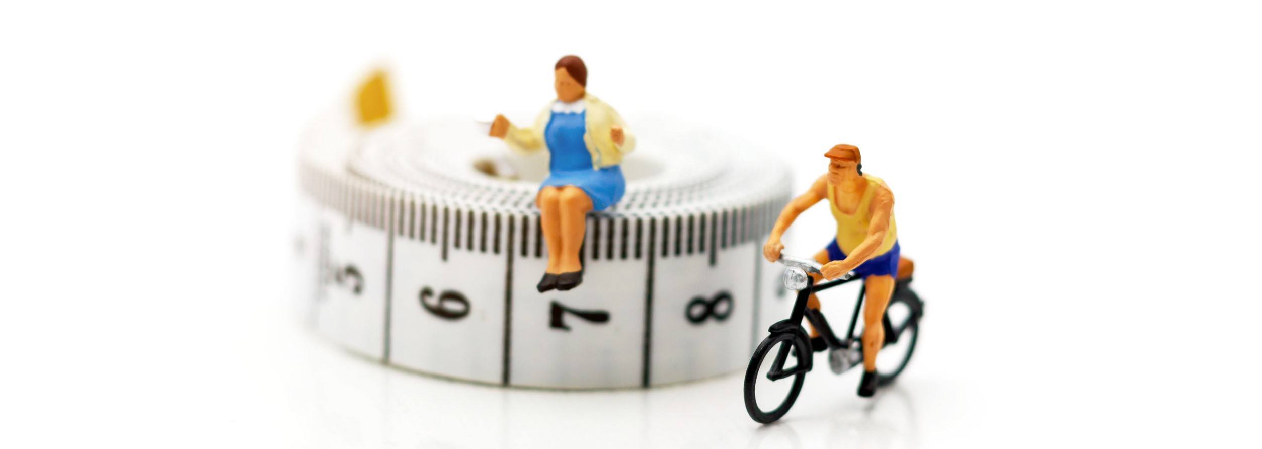 Miniature people enjoy riding a bicycle. Cycling for health Concept.