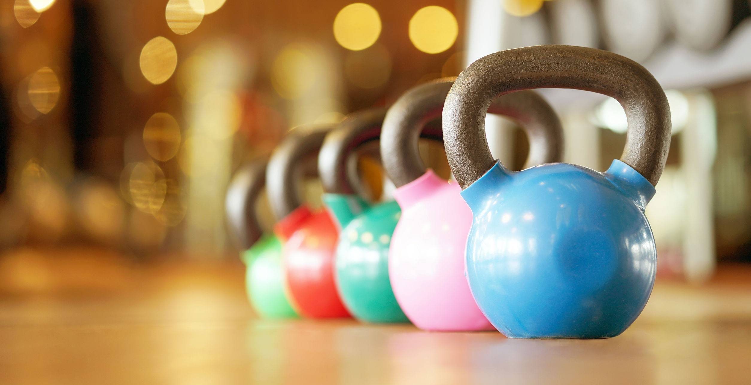 Colorful kettlebells in gym