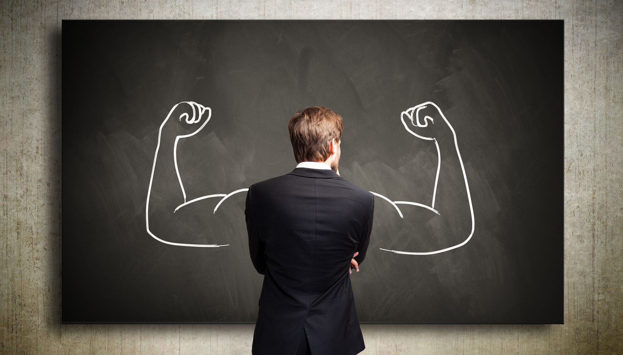 A man standing next to a painting with big arms