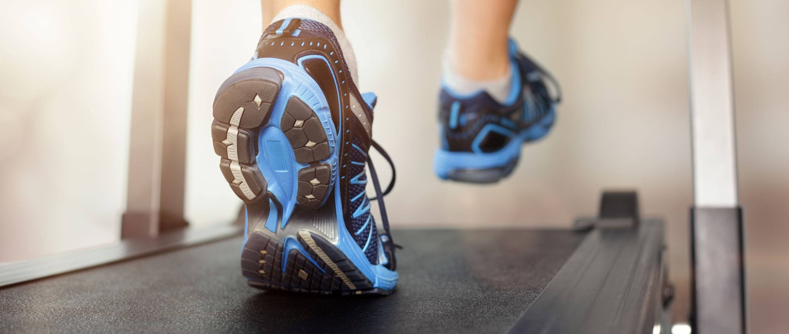 Man running in a gym on a treadmill 