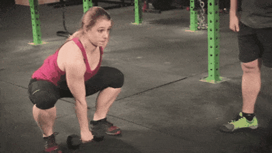 Coach Staci performing the dumbbell snatch