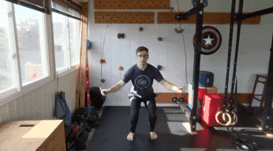 Coach Matt doing jump rope hops while in a squat position.