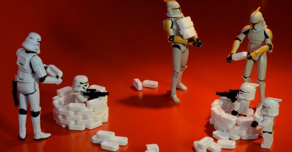 This picture some Stormtroopers and mini-stormtroopers play fighting.