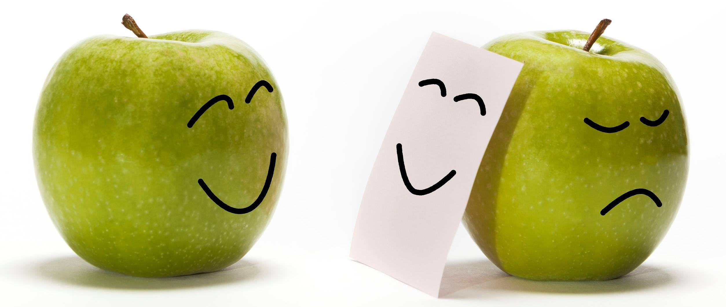 n apple smiling to other one that is concealing its sadness behind a smily mask