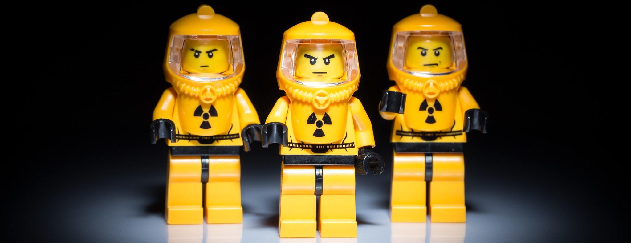 These three LEGOs in hazmat suits are probably on their way to the gym.