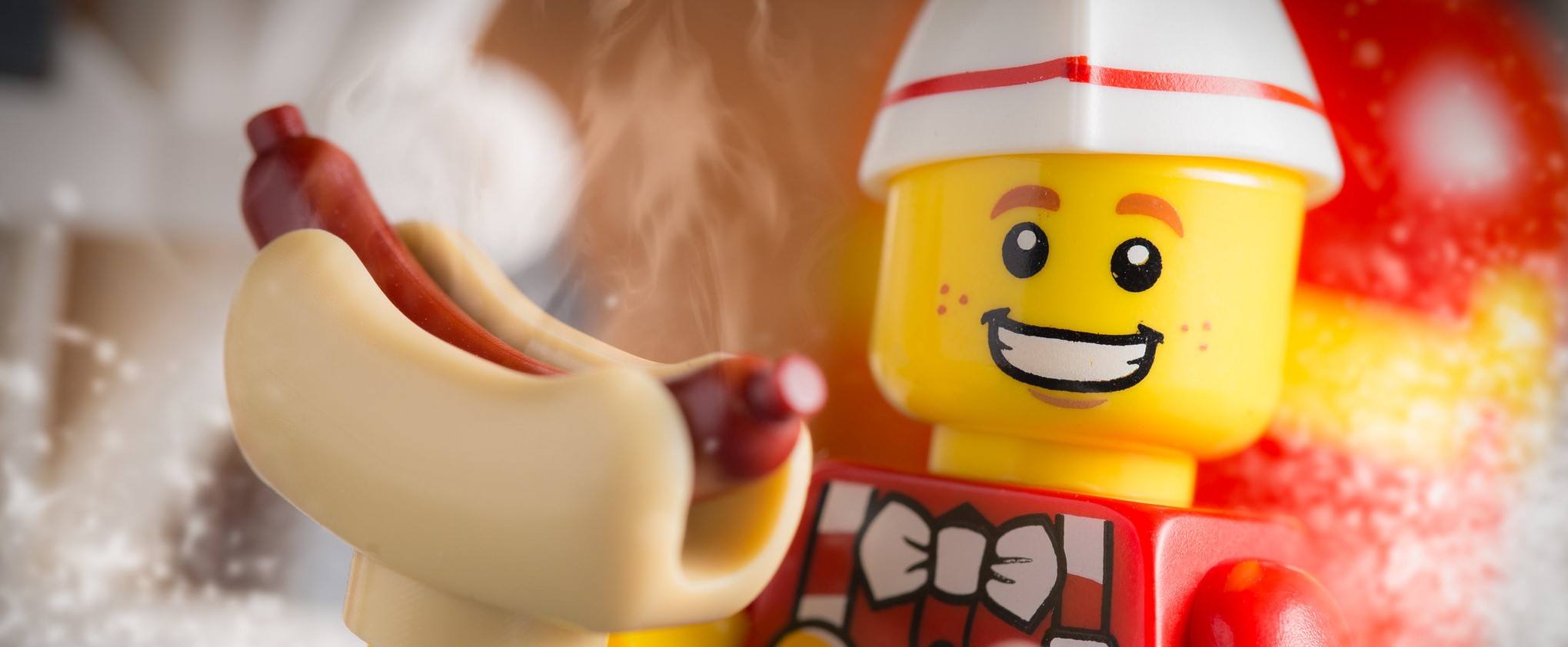 A LEGO holding a hot dog, which may help with his protein goals.