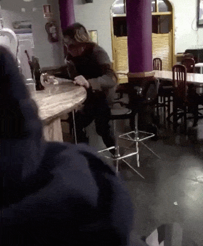 A drunk on a barstool falling over