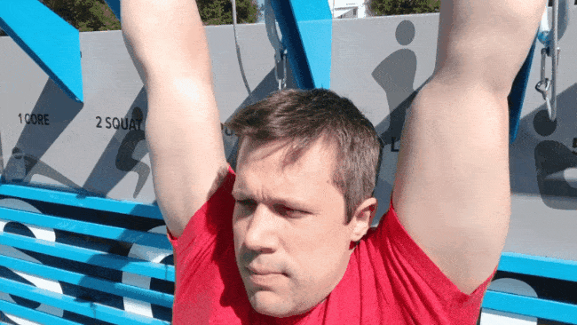 Coach Jim doing shoulder retracts, shown from the front.