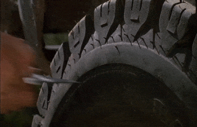 A man slashing a tire