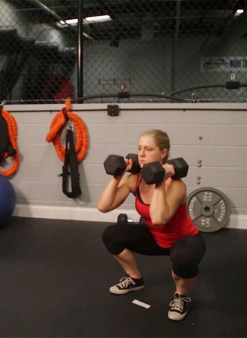 Coach Staci doing a dumbbell clean