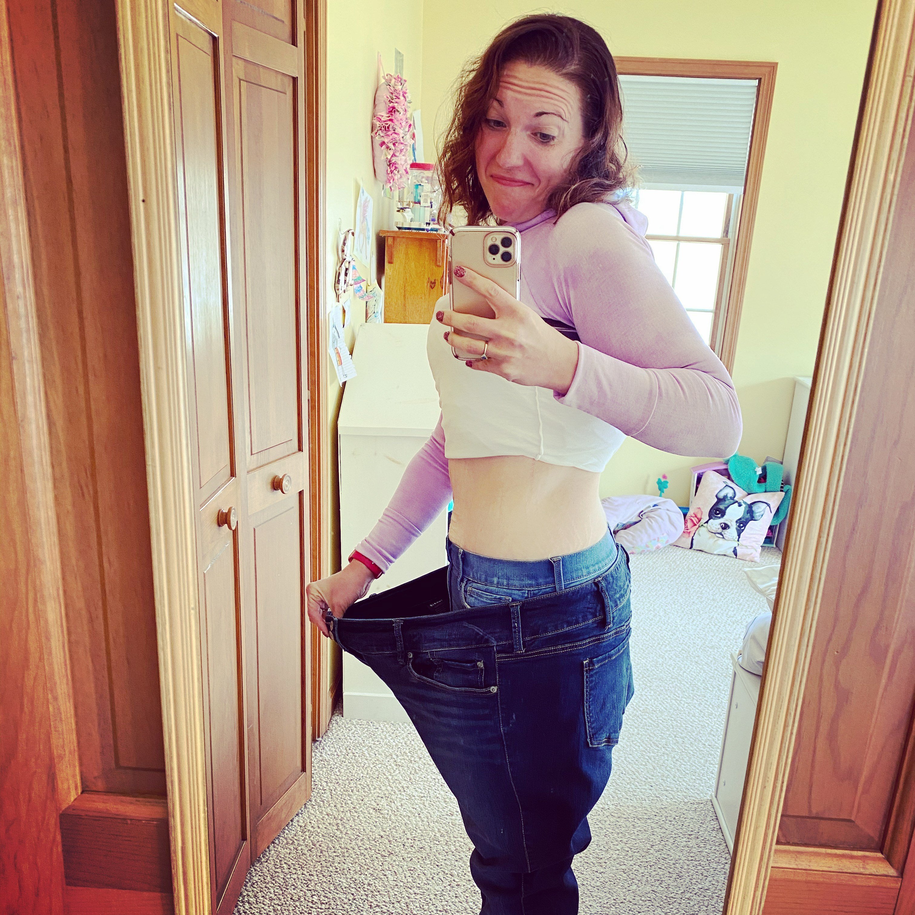 Megan wearing jeans standing inside her old jeans