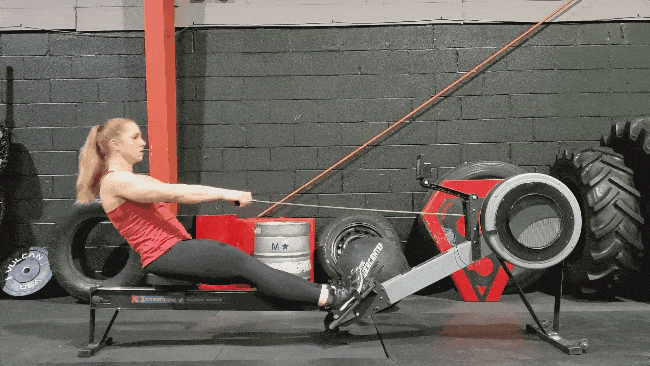 Coach Staci demonstrating a rowing drill by just using her arms while leaning.