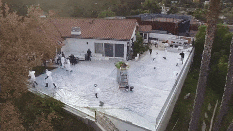 People running away from wave of exploding foam