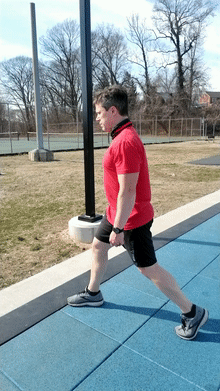This gif shows JCoach Jim doing a bodyweight split squat.