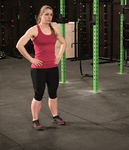 Coach Staci doing an lunge, and pausing at the bottom.