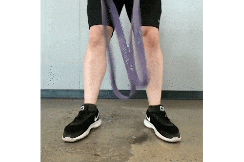 Coach Jim crisscrossing a resistance band, then stepping on it, for this deadlift variation.