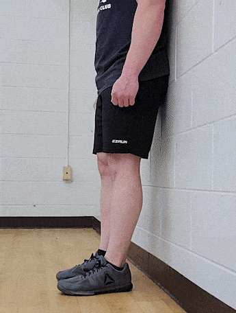 Coach Jim, doing a shin raise close to the wall.