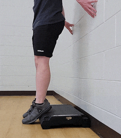 Coach Jim doing a shin raise, with his heel higher on a step.