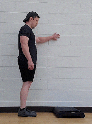 Coach Jim doing a standing calf raise from the floor.