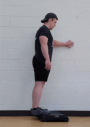 Coach Jim doing a standing raise from a step