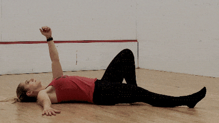 For those with added weight, lower it down with two hands, keeping it close, and then roll to the side to put it on the ground.