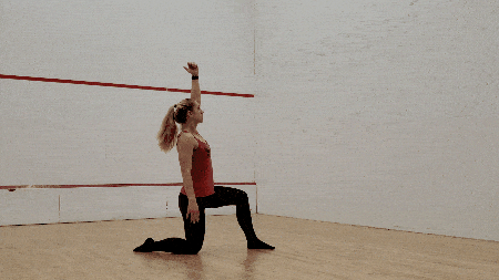 Stand up completely. This is the halfway point of the Turkish Get-up. 